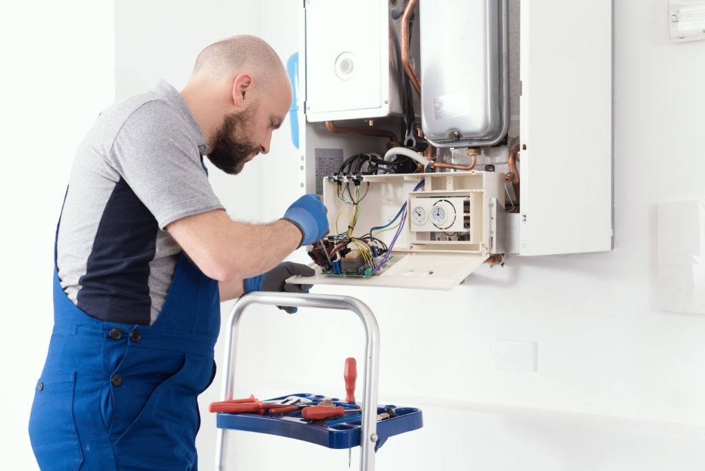 Qualified engineer servicing a boiler